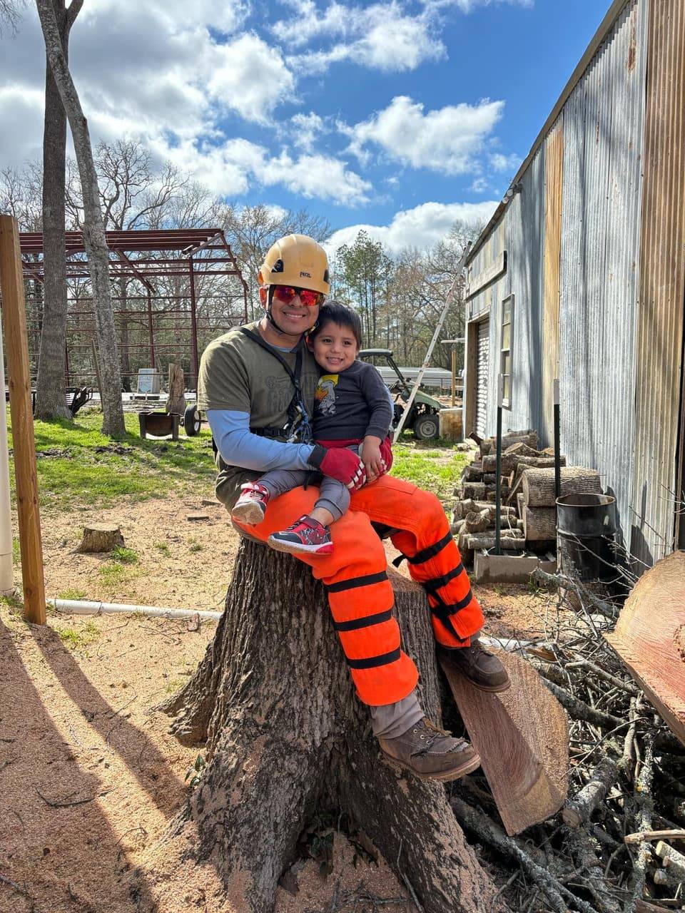Amaya Tree Service crew member with a young member of the family business near Huntsville, TX